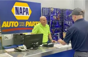 This image shows a customer buying an auto part at a local napa store