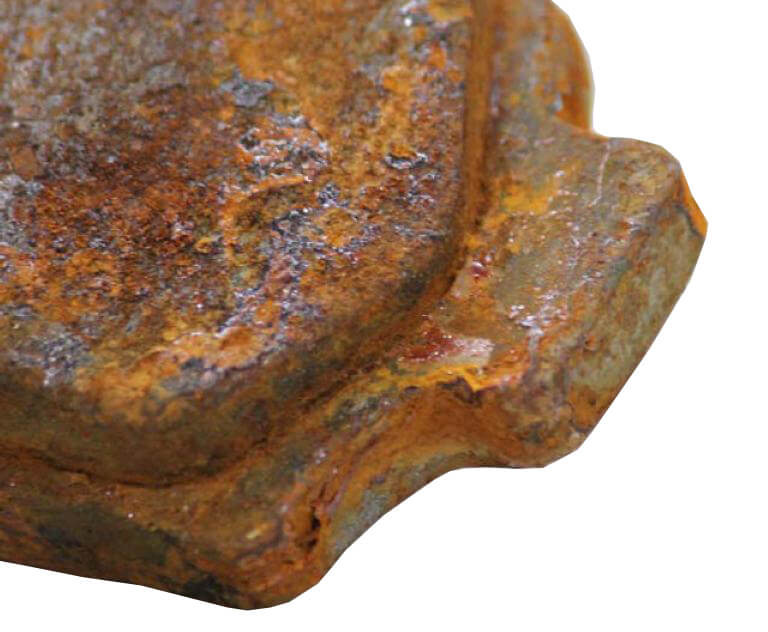 image of rusted brake pack backing plate and delaminated brake pad