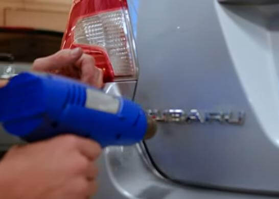 warm car emblem adhesive with a hair dryer