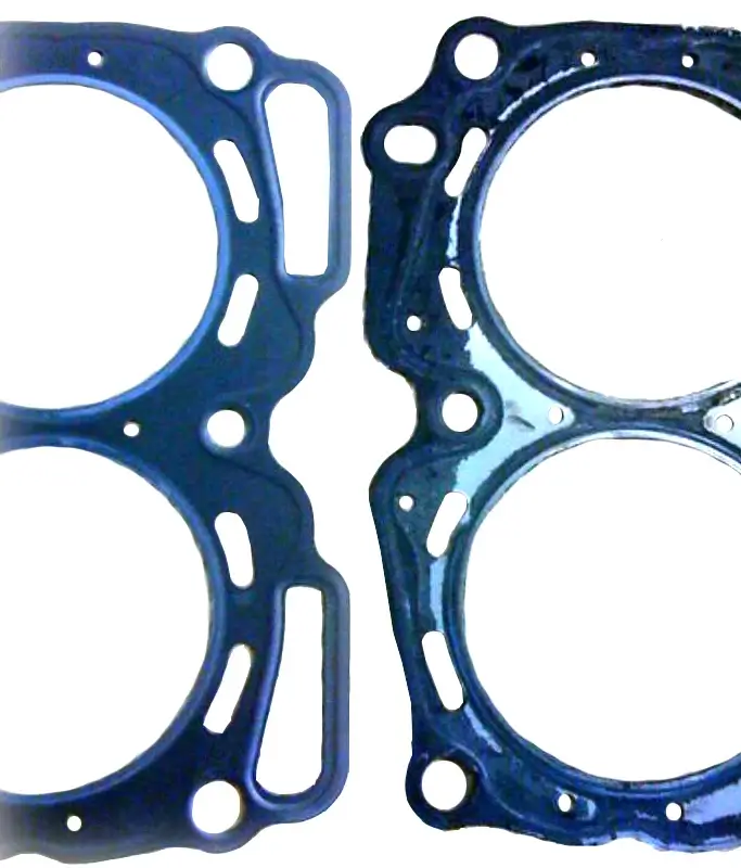 This image shows a new Subaru head gasket versus a degraded Subaru head gasket.