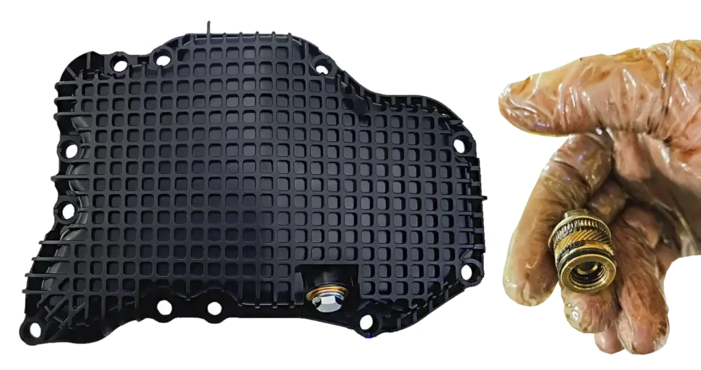 This image shows a Nissan plastic oil pan with metal drain plug insert