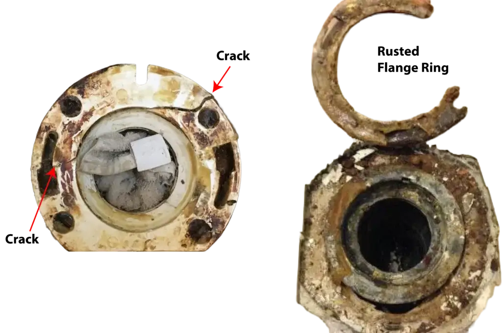 This image shows a cracked and rusted toilet flange